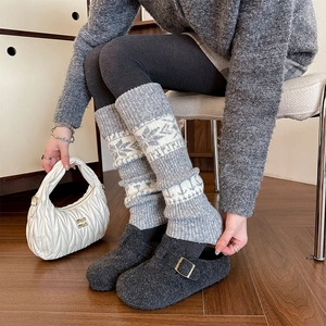 Winter grey knit leg warmers with snowflake pattern paired with wool felt clogs