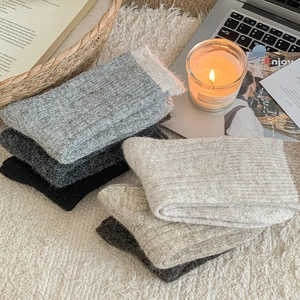 Detail of wool knit winter socks showing soft ribbed texture and neutral color palette