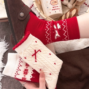 Detailed close-up of warm winter red socks with polka dots and 3D bow accents