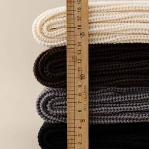 Detailed close-up of ribbed knit leg warmers showing thick texture and diverse colors