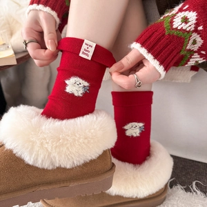 Festive red wool socks featuring cute puppy embroidery and white label detail