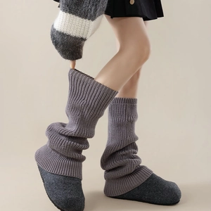 Detailed close-up of purple ribbed knit leg warmers showing thick vertical striped texture