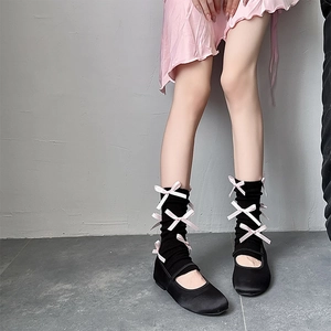 Balletcore knitted leg warmers in black featuring pink silk bows and Mary Jane flats