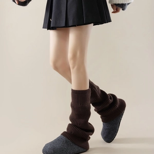 Close-up of deep brown ribbed knit leg warmers showing warm winter texture and elasticity