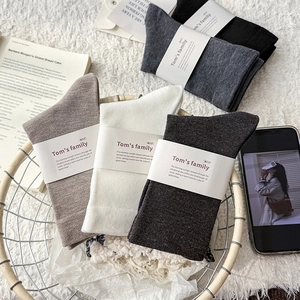 Detailed view of five-pair cotton crew socks set in various neutral tones and ribbed texture