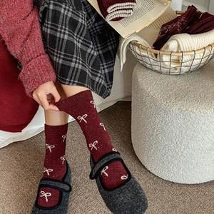 Winter wool crew socks with red velvet bow jacquard pattern for cozy warmth