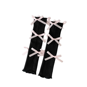 Balletcore black knit leg warmers with pink silk bows and ruffled lettuce trim