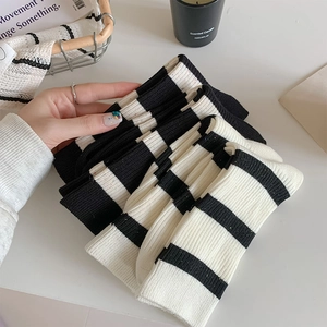 Detail of black and white striped cotton socks with ribbed texture and thick knitted fabric