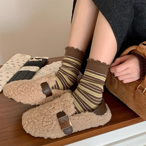Cozy brown faux fur mules with vintage buckle paired with striped crew wool socks