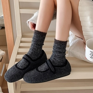 Thick warm crew socks for women in dark grey cable knit with minimalist Mary Jane shoes