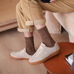 Men's retro beige suede sneakers with gum soles styled with wool socks and corduroy trousers