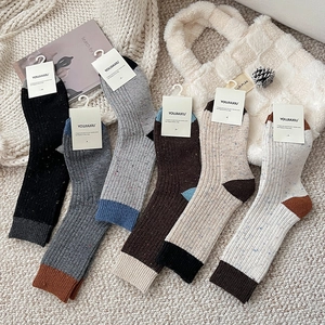 Detailed view of six pairs of wool socks in vintage colors with thick ribbed texture