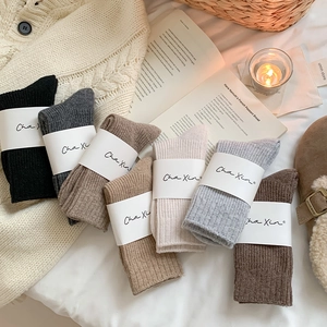Close-up of ribbed wool socks in earth tones like brown and beige for winter