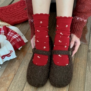 Retro red knit socks with floral patterns and ruffled edges paired with brown plush shoes