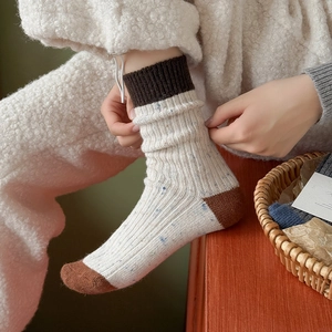 Macro shot of wool blend knit socks with contrasting heel and ribbed dark brown cuffs