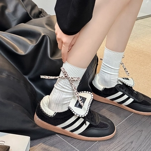 Japanese style white ribbed socks with leopard print bows and black classic sneakers