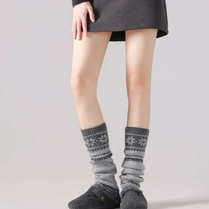 Detail of Fair Isle snowflake pattern on thick grey knitted leg warmers for women