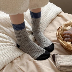 Thick wool blend mid-calf socks with contrast heels and vintage colorful flecked texture