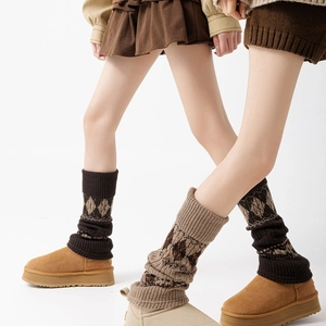 Detail of argyle pattern knitted leg warmers styled with winter boots for school look