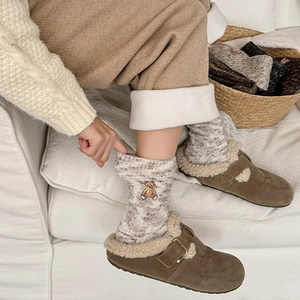 Thick warm knit bear socks with embroidery paired with cozy winter clogs on rug