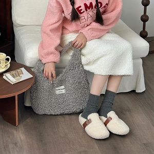 Detail of grey sherpa fleece tote bag with PROJECT BLISS label and cozy plush textures