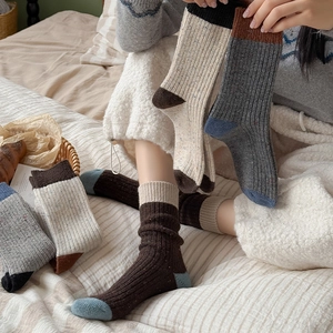Detailed close-up of ribbed texture and color-blocking design on thick wool socks