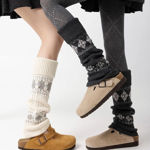 Detailed view of knitted leg warmers featuring vintage jacquard snowflakes and rhomb patterns