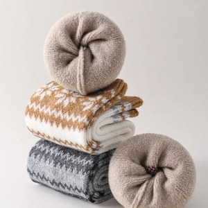 Detailed view of thick fleece lining on Nordic snowflake pattern knit leg warmers