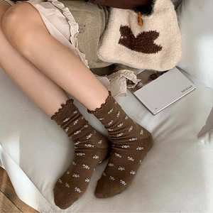 Brown floral knit socks with frilled edges in a cozy aesthetic lifestyle setting