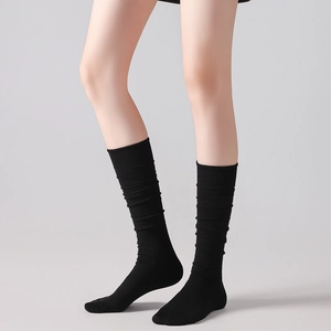 Detail of black wool calf socks with vertical ribbed knit texture for a slim leg look