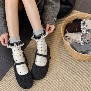 Close-up of vintage lace trim on plaid dotted wool socks with Mary Jane shoes