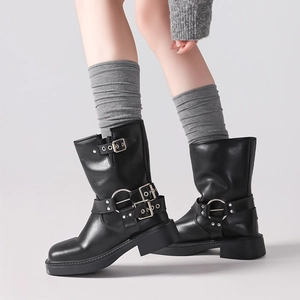 Detail of grey wool long socks paired with black buckle motorcycle boots for a chic look