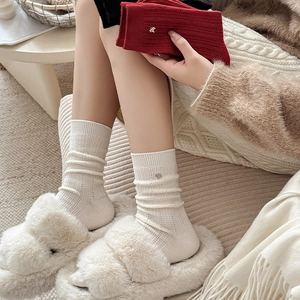 Red and cream wool blend socks with metallic accents and vertical knit texture