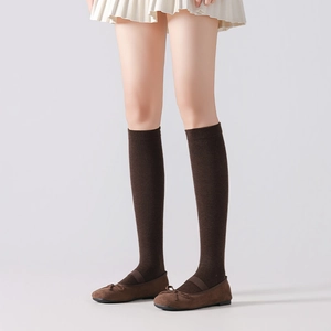 Detail of dark brown calf-high cotton socks with ribbed cuffs in Japanese school style
