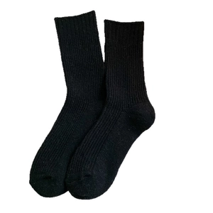Black ribbed wool mid-calf socks for women featuring minimalist vertical knit texture
