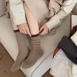 Close-up of thick ribbed knit socks with contrast trim in warm earth tones for winter