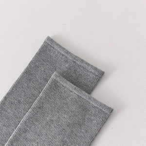 Detailed macro shot of marl grey wool knit socks showing ribbed texture and hem stitching