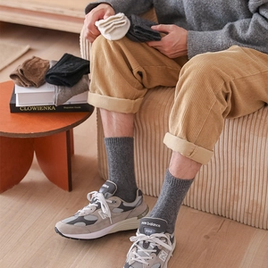 Close-up of thick knitted wool socks for men in various colors for autumn and winter