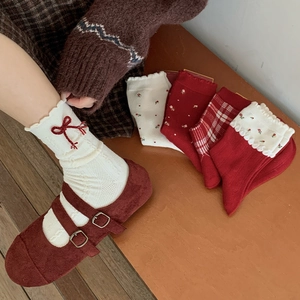 Detail of vintage knit socks with bow embroidery paired with Mary Jane shoes and patterns