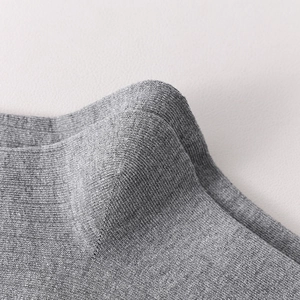 Macro shot of grey wool calf socks showing detailed rib knit texture and smooth stitching