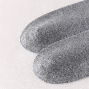 Detailed macro view of the seamless toe stitching and knit texture of grey cotton socks