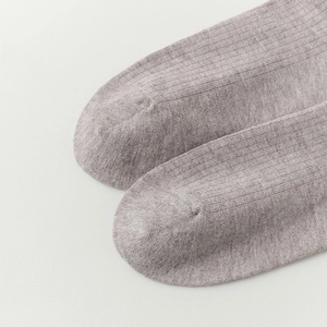 Macro view of seamless toe stitching and heathered taupe knit texture on wool socks