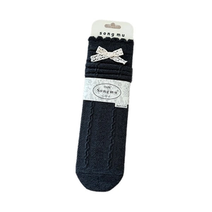 Vintage black cable knit crew socks with white lace bow and ruffled trim for women