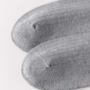 Detailed close-up of gray wool-blend ribbed socks featuring flat-seam toe construction