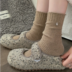 Fuzzy Mary Jane shoes with velcro strap shown with ribbed knit socks for winter comfort