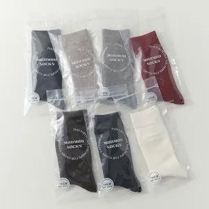 Detailed view of multi-color ribbed wool socks in individual premium packaging bags