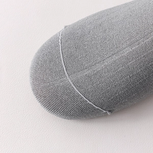 Detail of the gray wool sock showing fine knit texture and flat seam craftsmanship