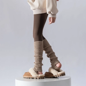 Detailed knit texture of ribbed leg warmers with open heel design for a cozy autumn style