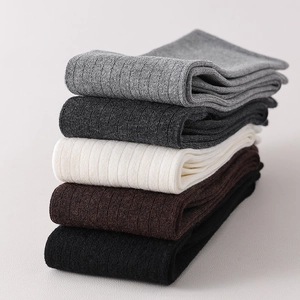 Detail showing the fine ribbed texture and elastic wool fabric of multi-color socks