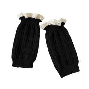 Knit leg warmers in black with lace trim and cable stitch pattern for winter boots